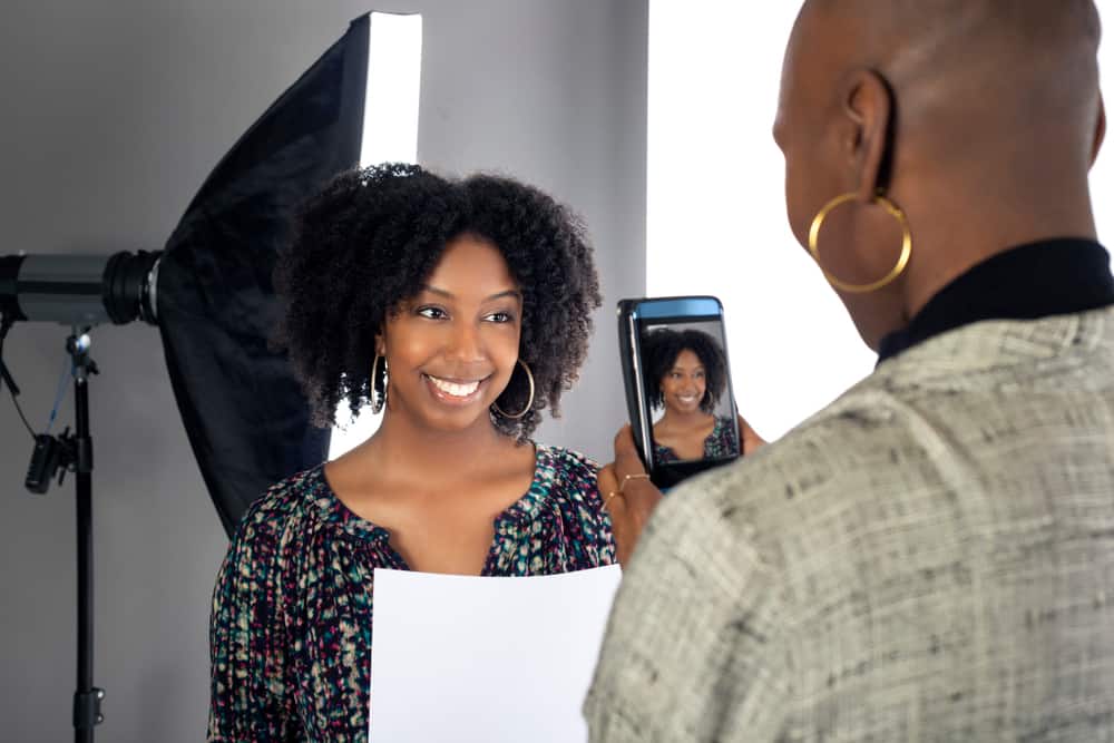 Casting assistant taking a snapshot of an actress in casting office