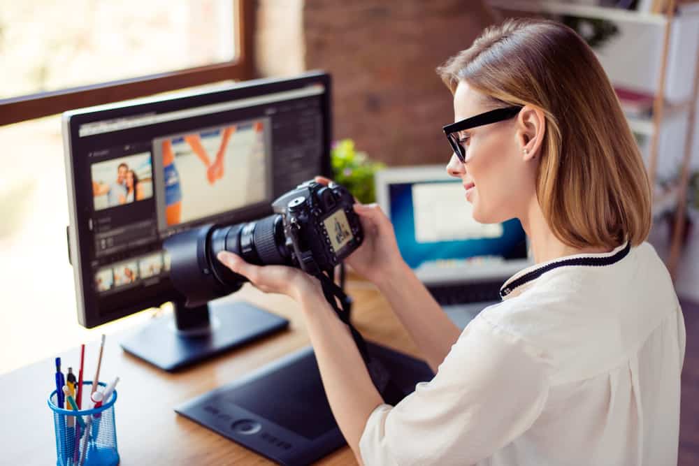Actor holding camera while editing her demo reel