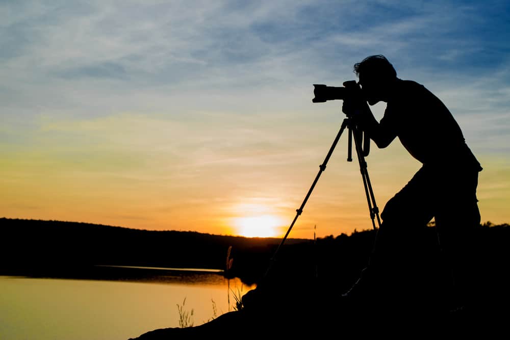 Cinematographer composing mise en scene outdoors